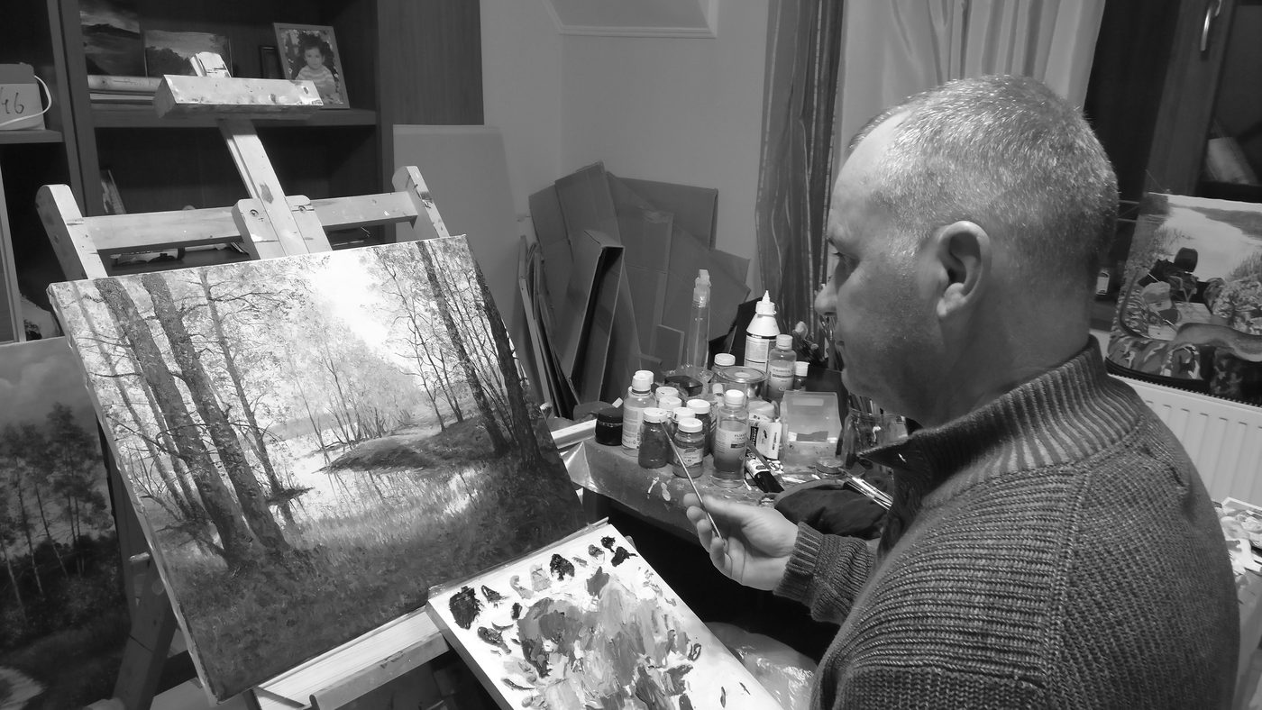 Viktor Kucheryavyy painting a landscape in his studio